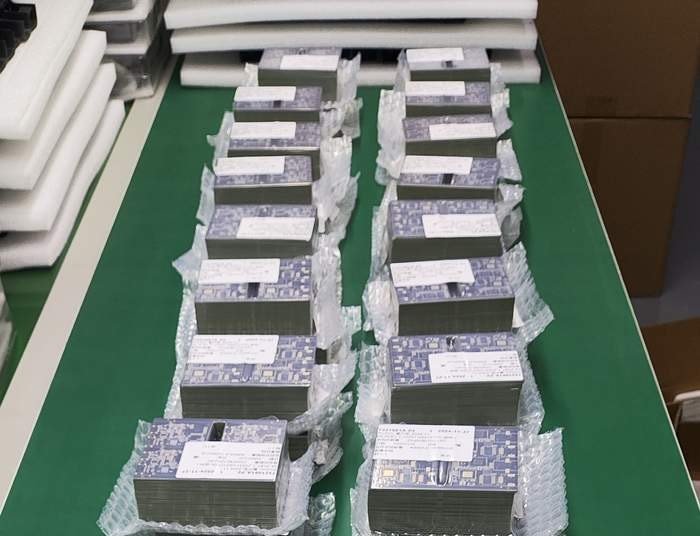 Freshly finished JetKVM PCBs stacked in protective trays.