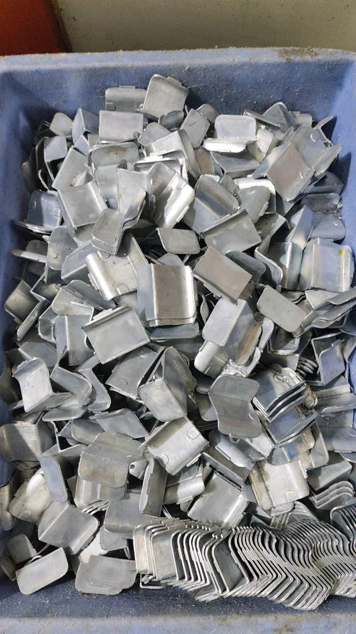 A tray of JetKVM backplates after CNC post-processing.