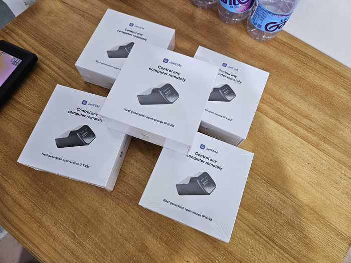 JetKVM retail packaging stacked together before shipment.