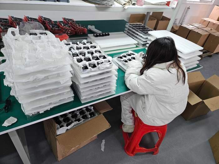 JetKVM cases being inspected during final quality control.