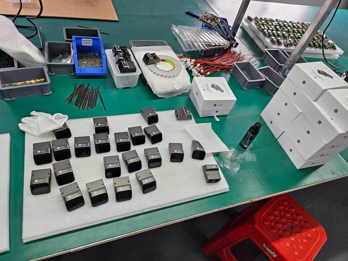 Pre-production JetKVM units lined up after assembly and ready for packaging.