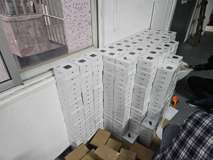 Stacks of assembled JetKVM packages sealed and ready for delivery.