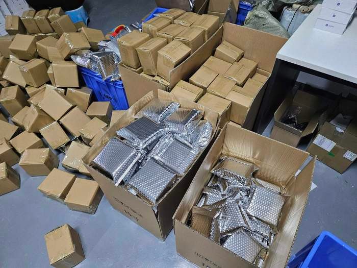 Shipping cartons and JetKVM packages staged for outbound shipments.